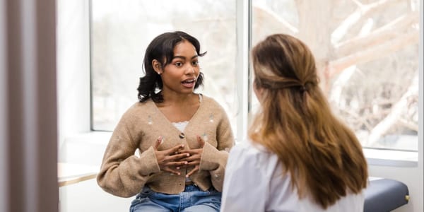 Young woman in a medical consultation discussing hormonal health
